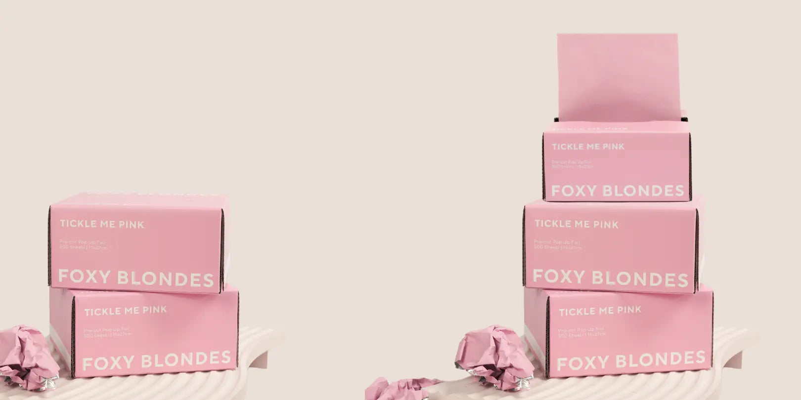 Two stacks of Foxy Blondes 'Tickle Me Pink' pre-cut pop-up hair foil boxes (500 sheets, 15x27cm), one stack of two and one of three, displayed on pink ridged stands with crumpled foils and one foil dispensing.